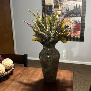 Decorative metal embossed vase with artificial plants and flowers
